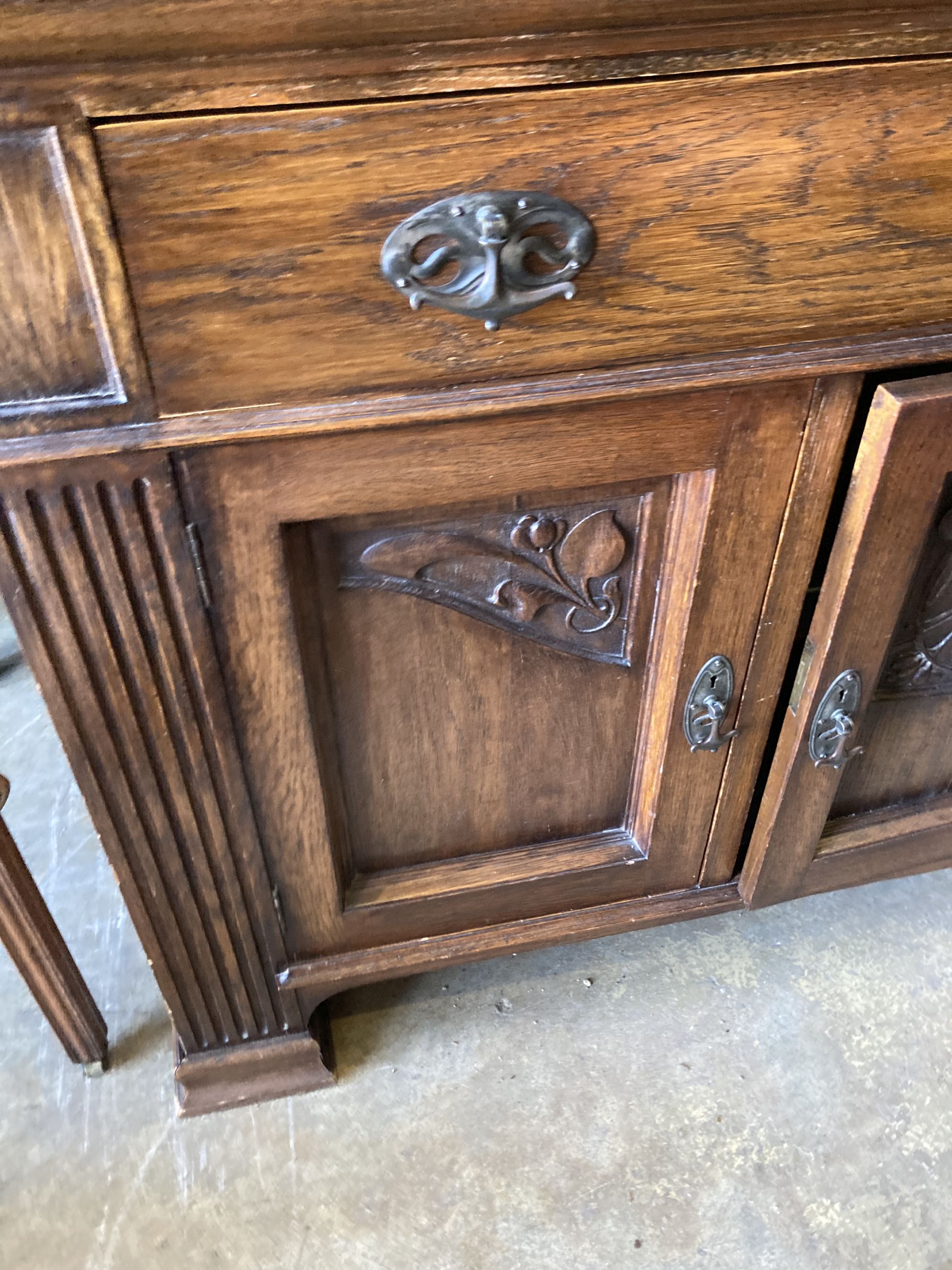 A late Victorian Art Nouveau carved oak sideboard, length 186cm, depth 62cm, height 102cm